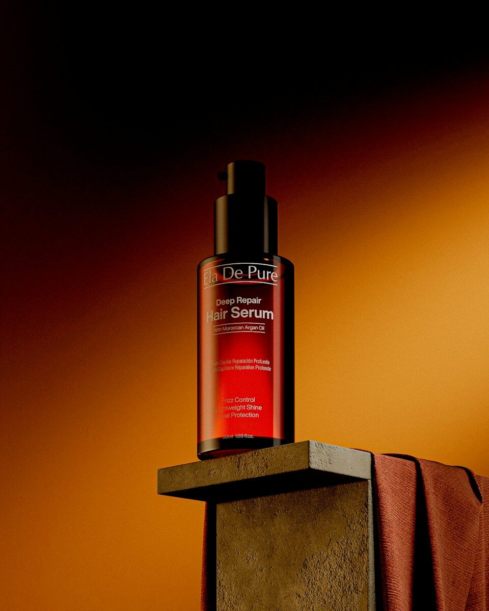 Red hair serum bottle on wooden block with fabric