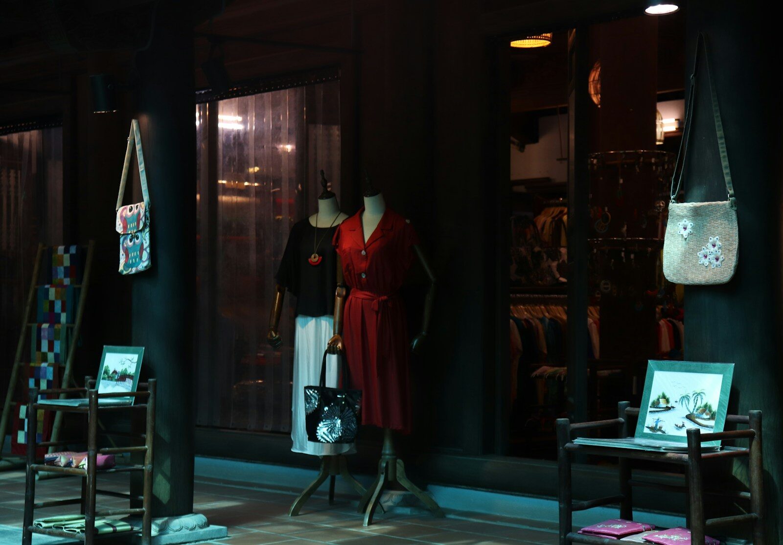 mannequins in a window display in a dark room